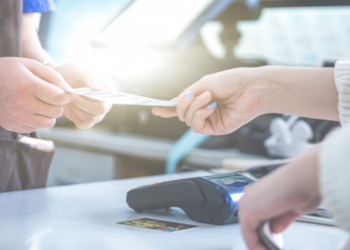 Imagem de uma pessoa fazendo um pagamento em uma máquina de cartão