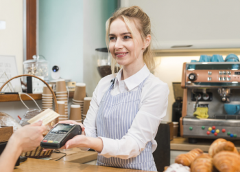 mulher segurando uma maquininha de cartão